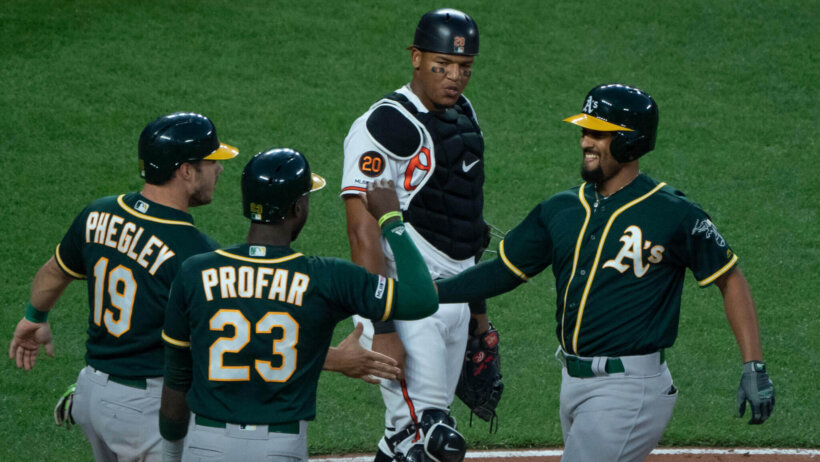 Oakland A's celebrate a run against Baltimore.