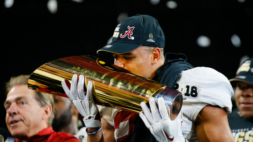 Minkah Fitzpatrick kisses the CFP Championship Trophy