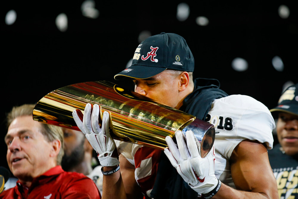 Minkah Fitzpatrick kisses the CFP Championship Trophy