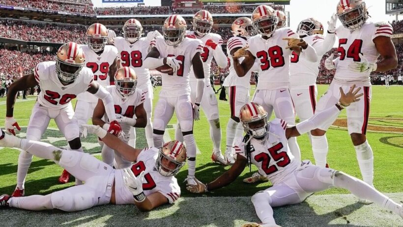 49ers defense posing for a picture in the end zone