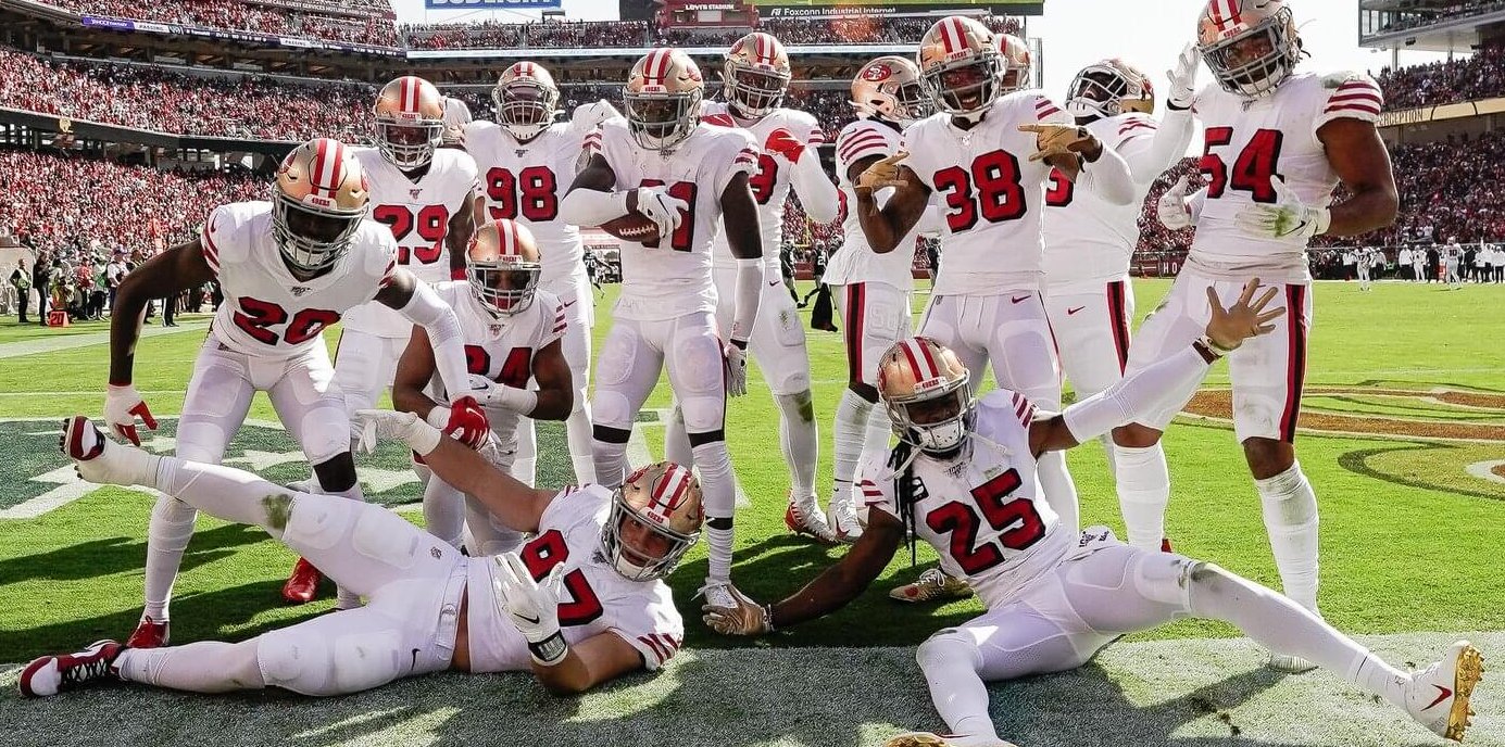 49ers defense posing for a picture in the end zone