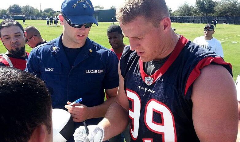 JJ Watt signs autographs for fans.