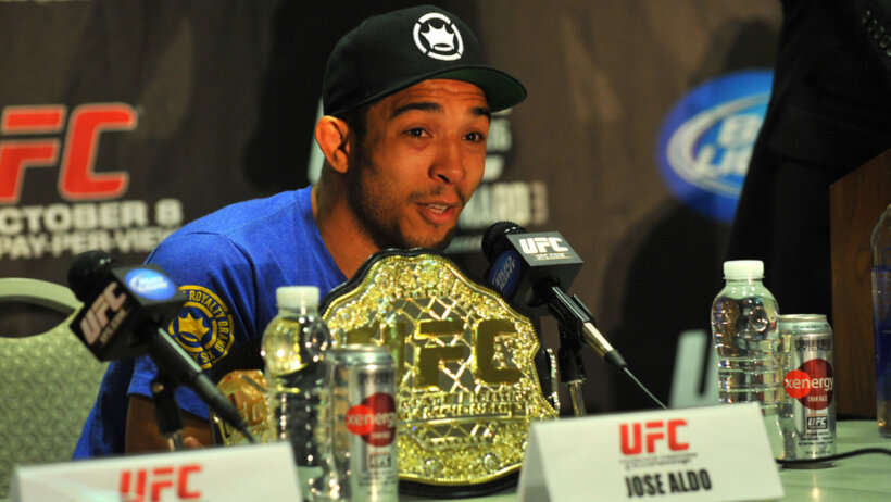 ose Aldo talking to the media during UFC 136