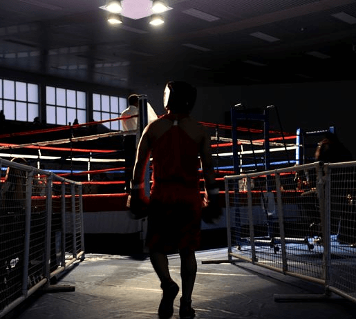 A silhouetted boxer entering the ring.