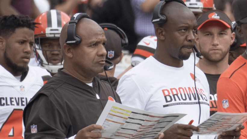 Former Browns HC Hue Jackson looking at his playsheet.