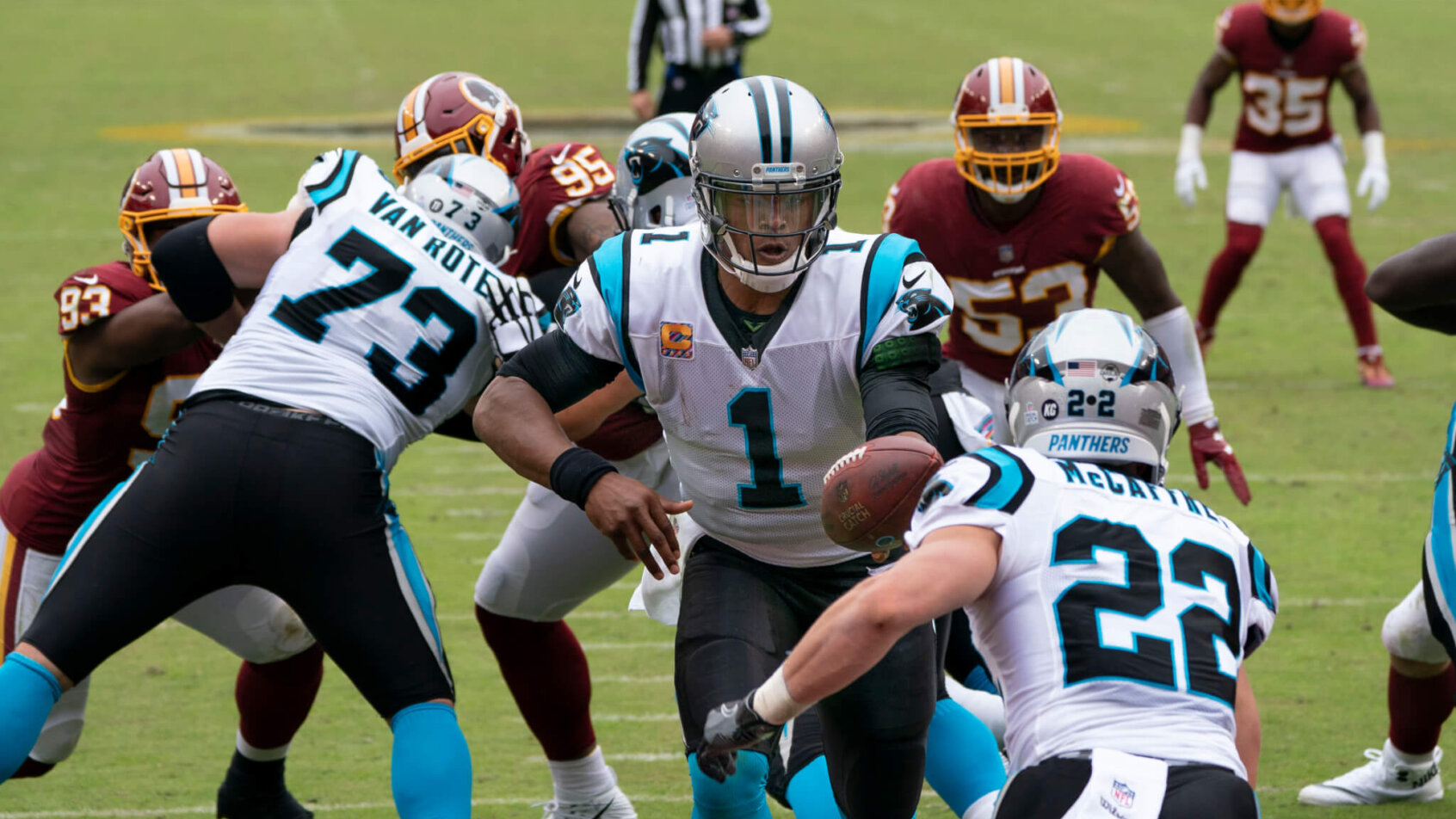 Cam Newton handing the ball off