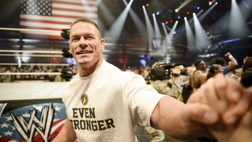 Professional wrestler John Cena shakes hands with a child, Dec. 11, 2013, at the conclusion of the WWE Tribute to the Troops event at Joint Base Lewis-McChord, Wash. The event entertained approximately 4,000 service members and family members stationed throughout the Puget Sound area.