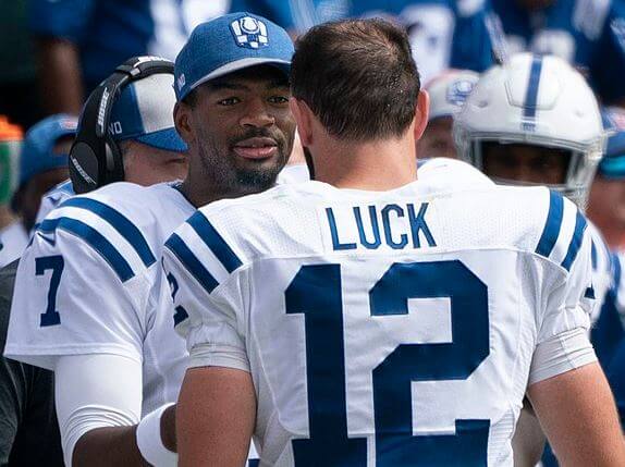 Jacoby Brissett high fiving Andrew Luck on the Colts sideline