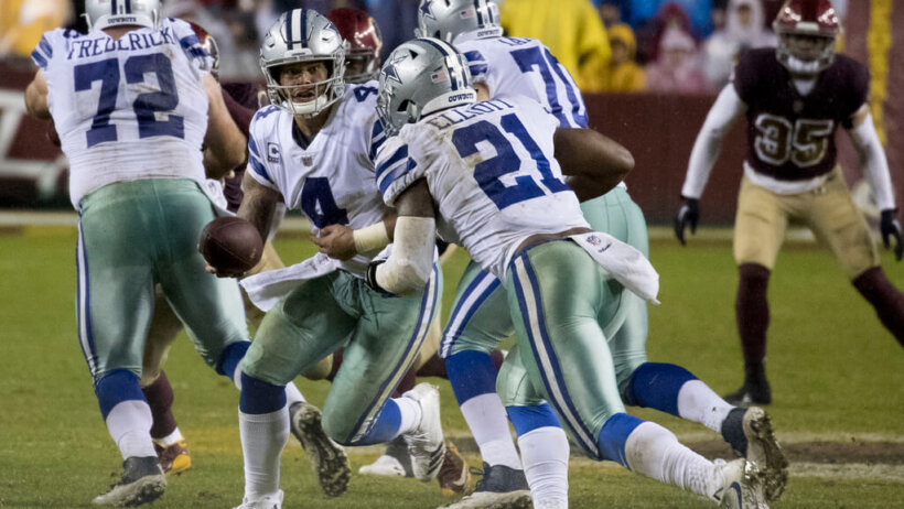 Cowboys RB Ezekiel Elliott takes a handoff from Dak Prescott.