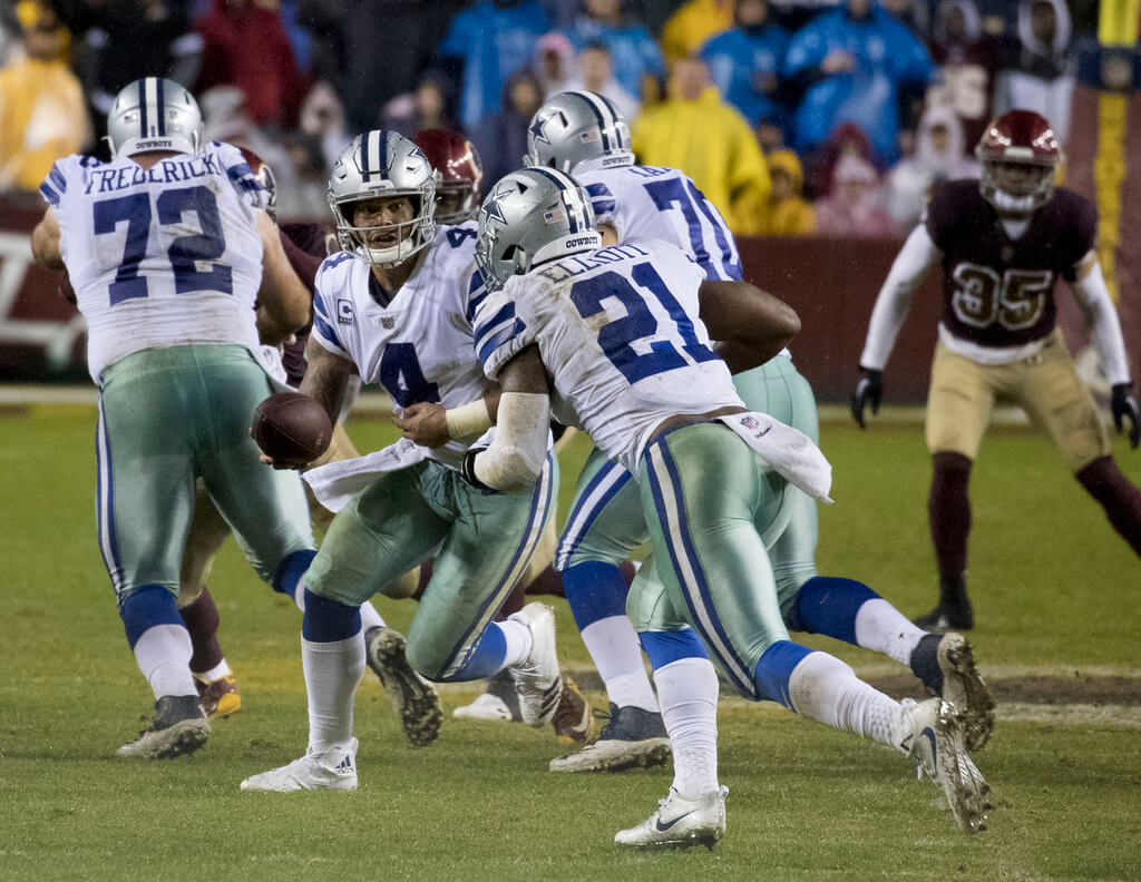 Cowboys RB Ezekiel Elliott takes a handoff from Dak Prescott.