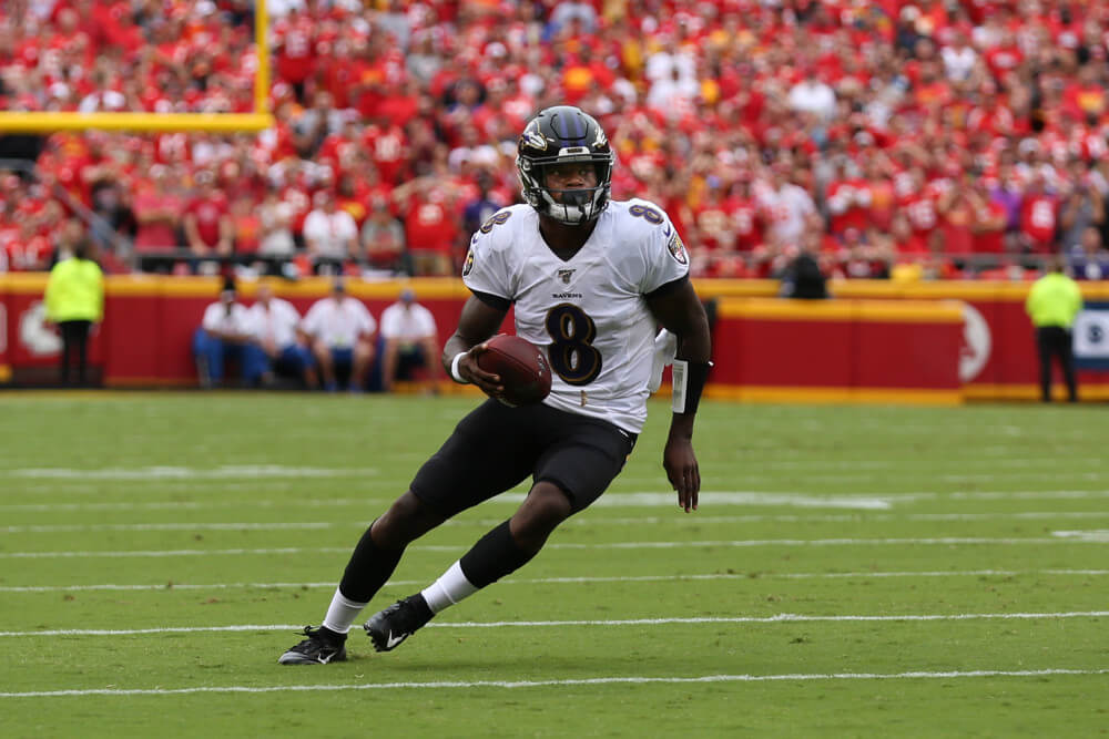 Lamar Jackson tucking the ball to run