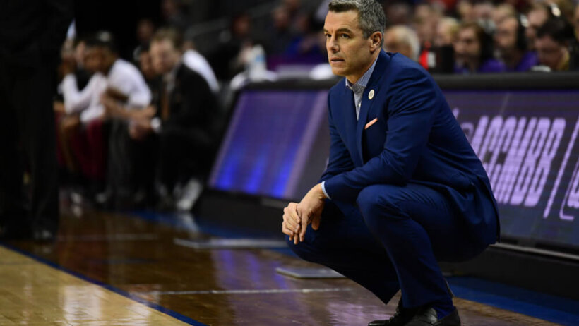 Tony Bennett crouching on the sideline