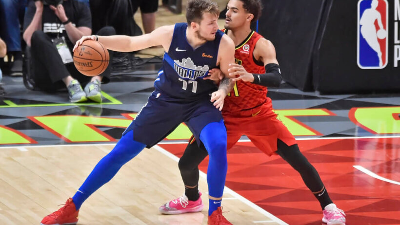 Luka Doncic backing down Trae Young.