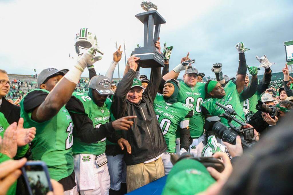 Marshall head coach Doc Holliday celebrates a bowl victory