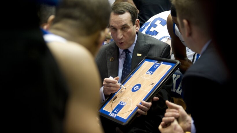 Duke coach Mike Krzyzewski huddles with his players.