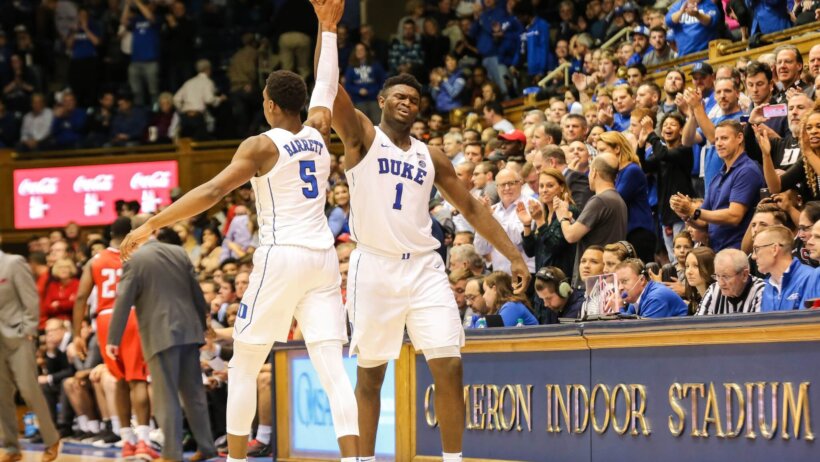 RJ Barrett and Zion Williamson high-fiving.