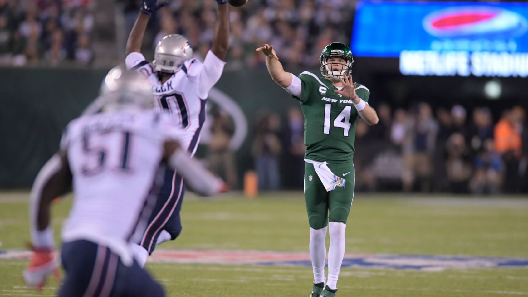 Sam Darnold throws an interception against the Patriots