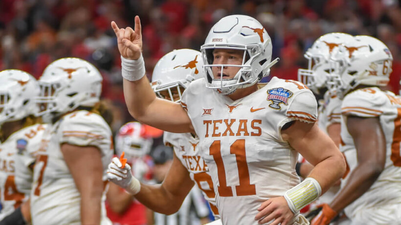 Texas QB Sam Ehlinger flashing the horns