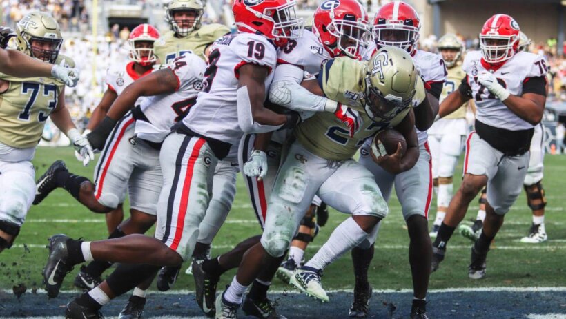 Georgia Bulldog defense making a gang tackle