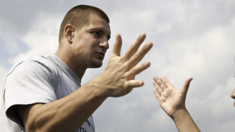 Rob Gronkowski of the New England Patriots high-fives a camper