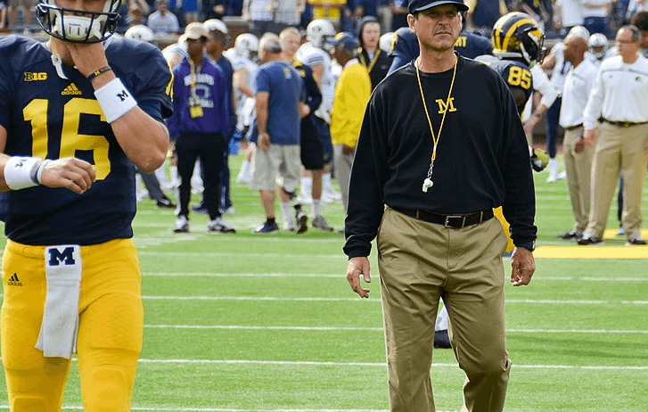 Jim Harbaugh walking across the field at the Big House