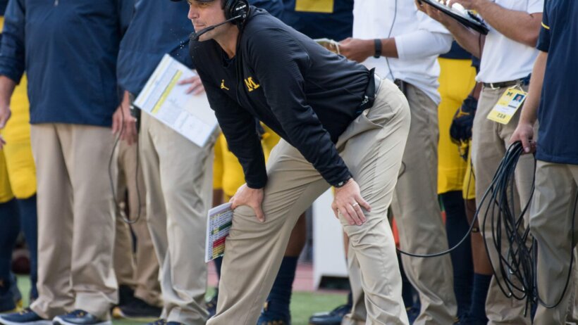 Jim Harbaugh watching play from the sidelines