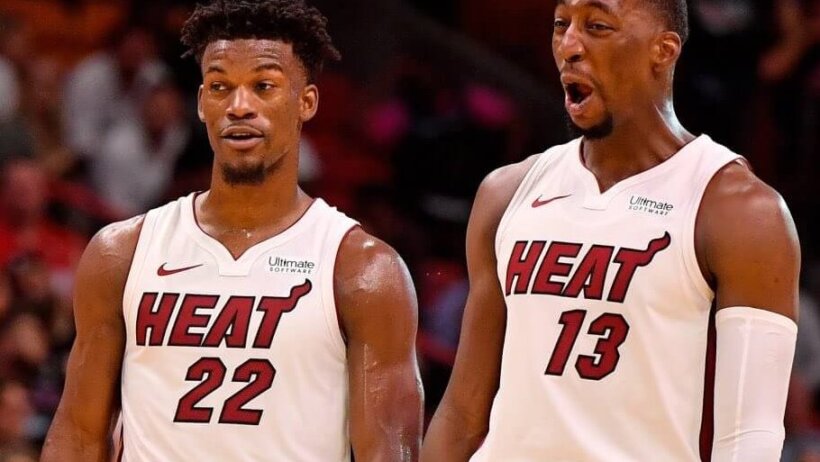 Jimmy Butler and Bam Adebayo reacting during a stoppage in play