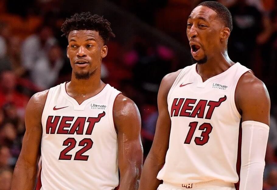 Jimmy Butler and Bam Adebayo reacting during a stoppage in play