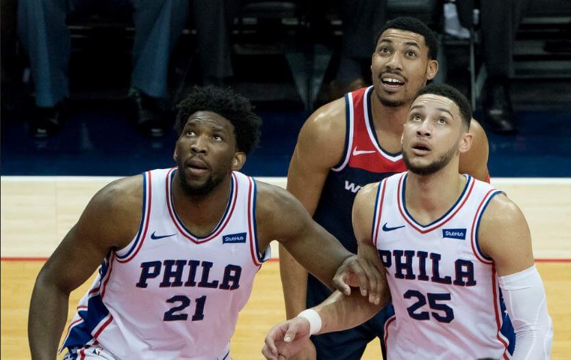 Joel Embiid and Ben Simmons waiting to grab a rebound