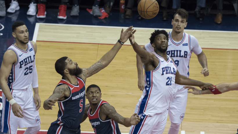 Joel Embiid reaching for a rebound