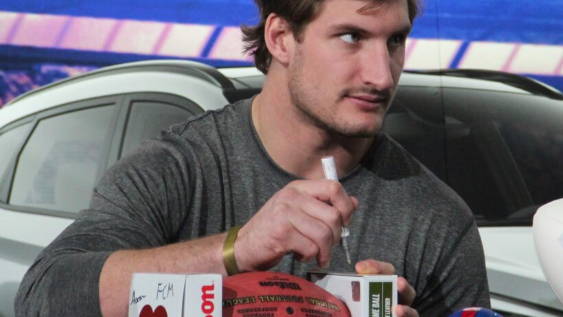Joey Bosa signing a football