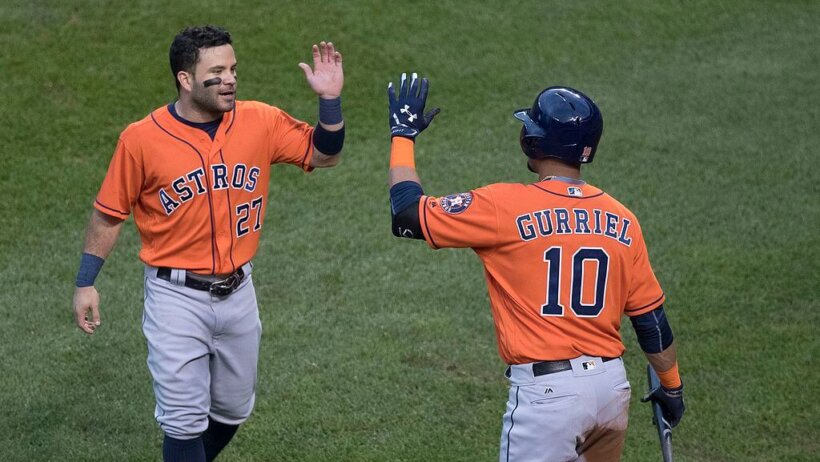 Jose Altuve high-fiving Yuli Gurriel