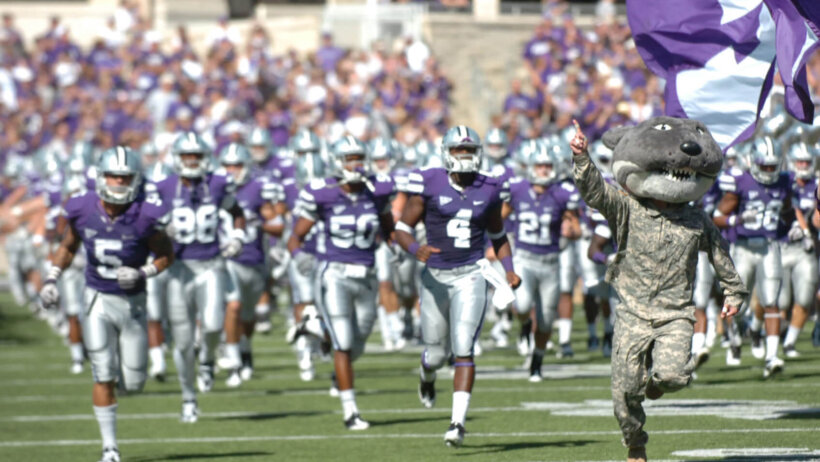Wildcat Willie, the Kansas State University Mascot, runs on to the field with the Kansas State Football Team