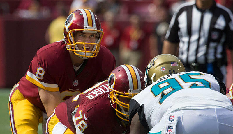 Kirk Cousins taking a snap