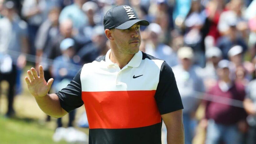 Brooks Koepka waves to gallery.
