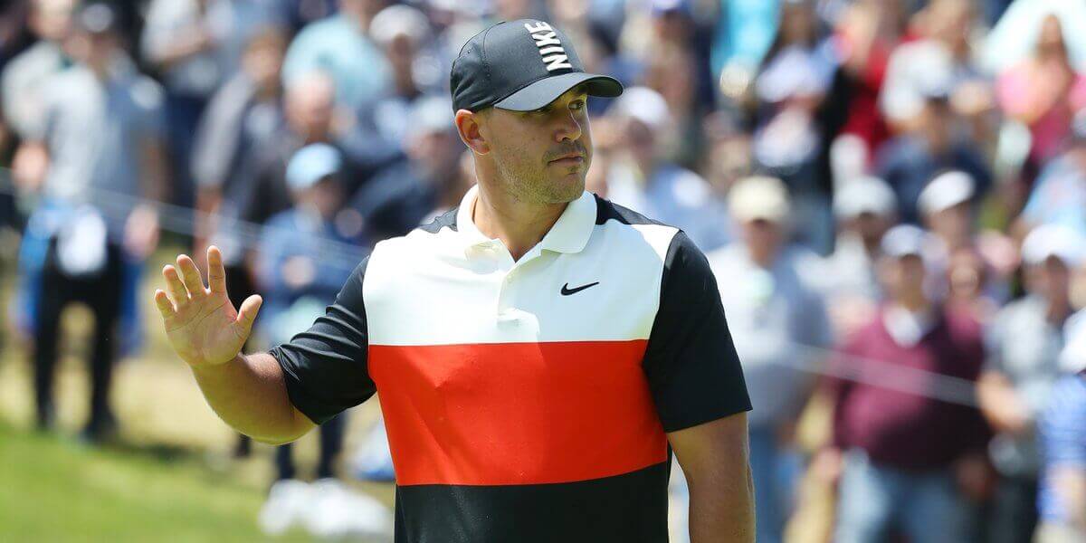 Brooks Koepka waves to gallery.