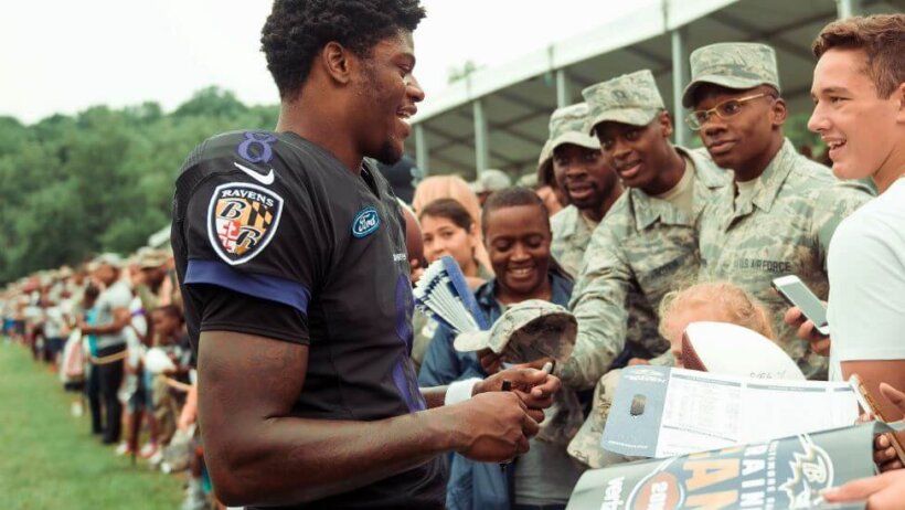 Lamar Jackson signing autographs for the troops