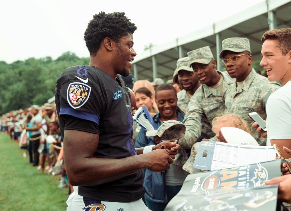 Lamar Jackson signing autographs for the troops