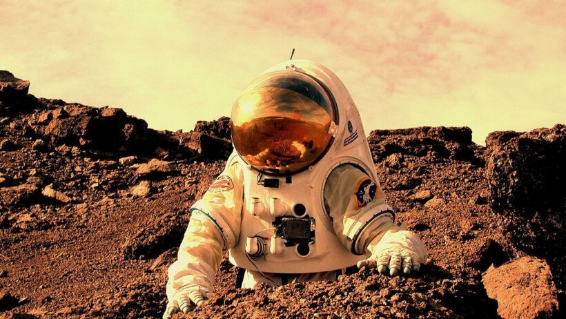 An image of an astronaut on a foreign planet.