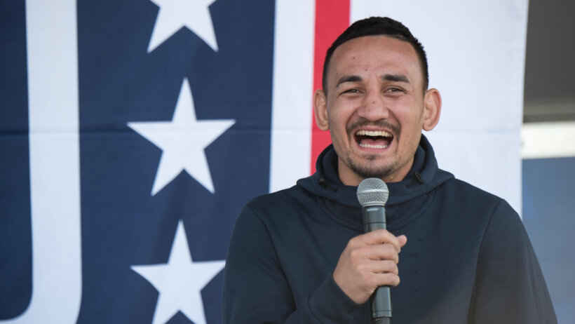 Max Holloway with a mic in hand.