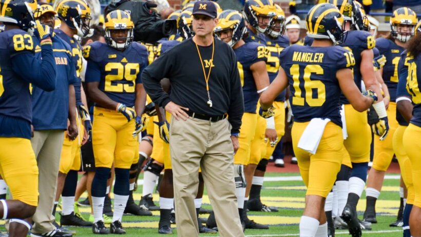 Jim Harbaugh with his Michigan team before kickoff.