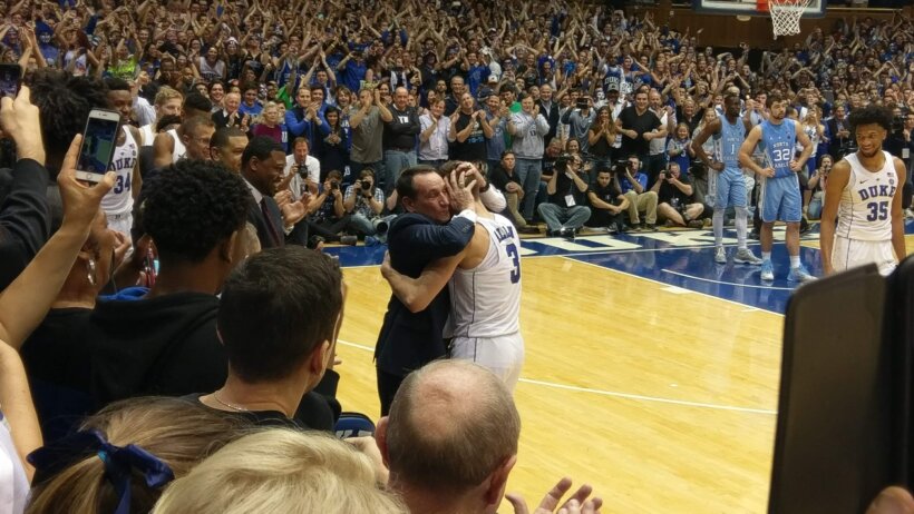 Mike Krzyzewski hugging Grayson Allen after a Duke basketball game.