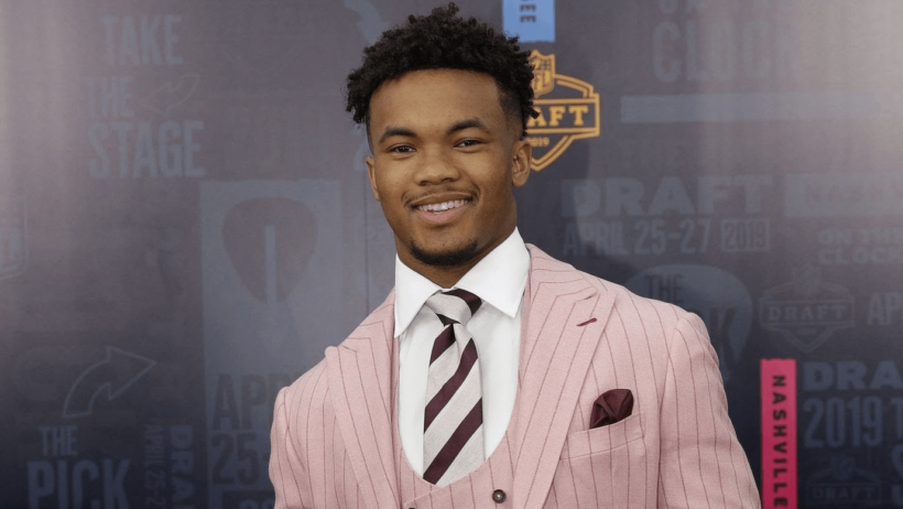 Kyler Murray smiling in a suit