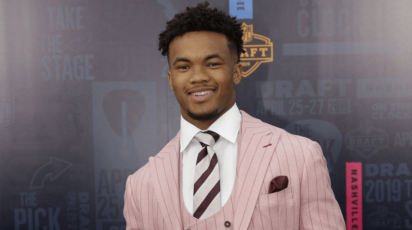 Kyler Murray smiling in a suit