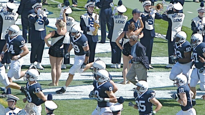 Penn State players running onto the field.