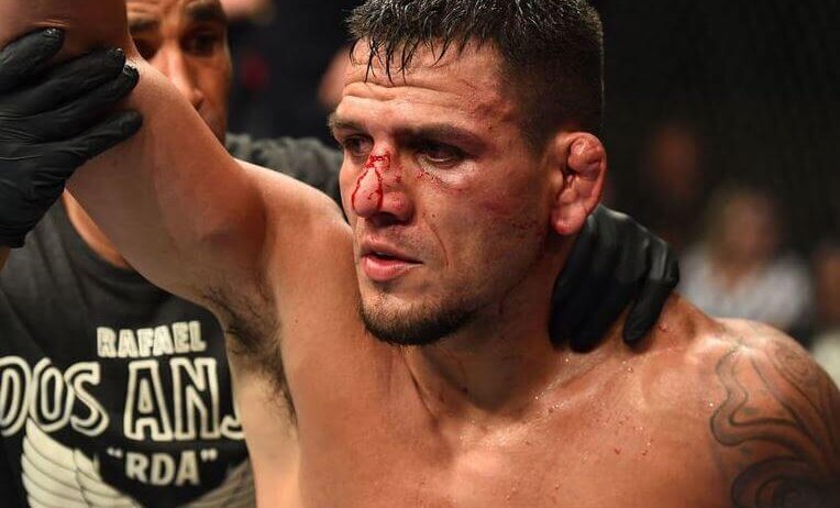 Rafael dos Anjos raising his hand in victory after submitting Kevin Lee.