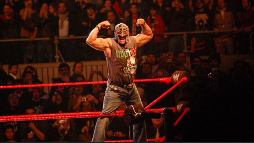 Rey Mysterio flexing on the top rope