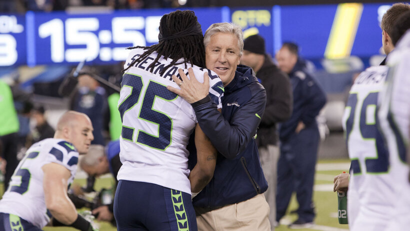Sherman and Pete Carroll hugging