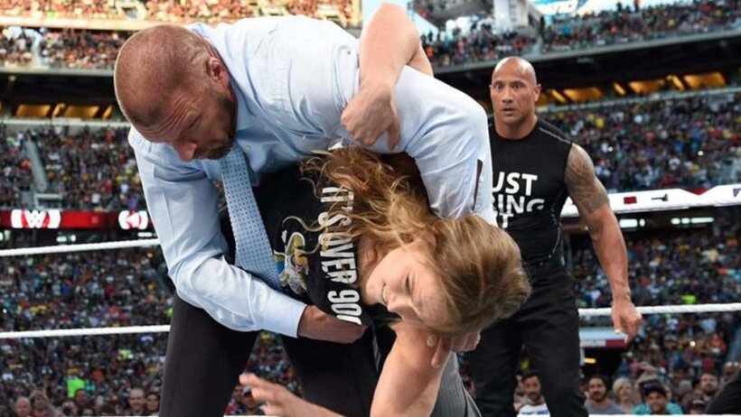 Ronda Rousey flipping HHH out of a ring at Wrestlemania 32