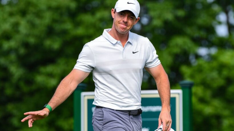 Rory McIlroy waving to a fan